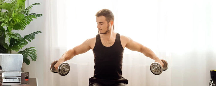 Seorang pria sedang melakukan incline dumbbell curl dengan posisi duduk untuk melatih otot biceps secara optimal