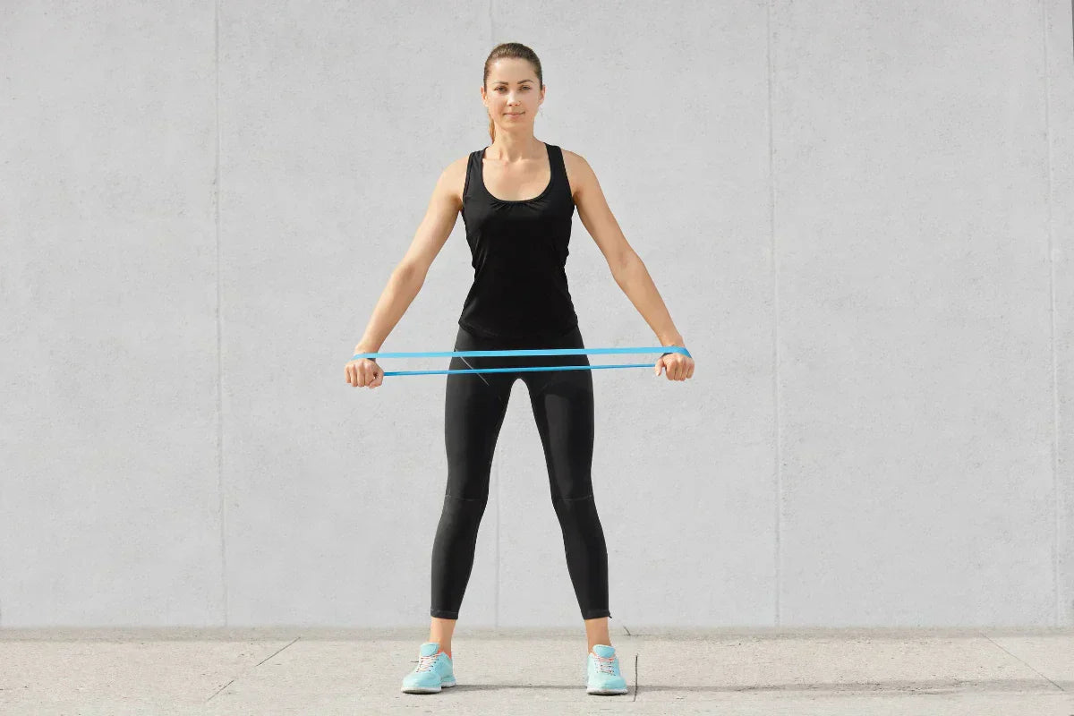 Seorang wanita yang hendal berolahraga dengan resistance bands